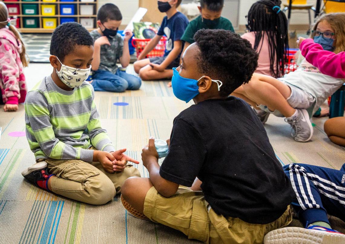 Daren Dean, 8, left, and Nedu Emelife, 8, discuss what they’re learning in Bria Wright’s second grade class at Hortons Creek Elementary School, on Thursday, May 6, 2021, in Cary, N.C.