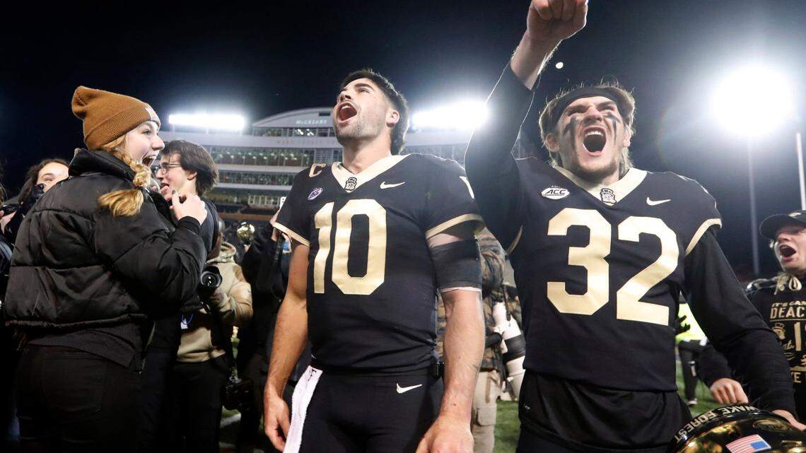 Wake Forest quarterback Sam Hartman (10) and wide receiver Jarrett Brown (32) celebrate after Wake Forest’s 45-42 victory over N.C. State at Truist Field in Winston-Salem, N.C., Saturday, November 13, 2021.