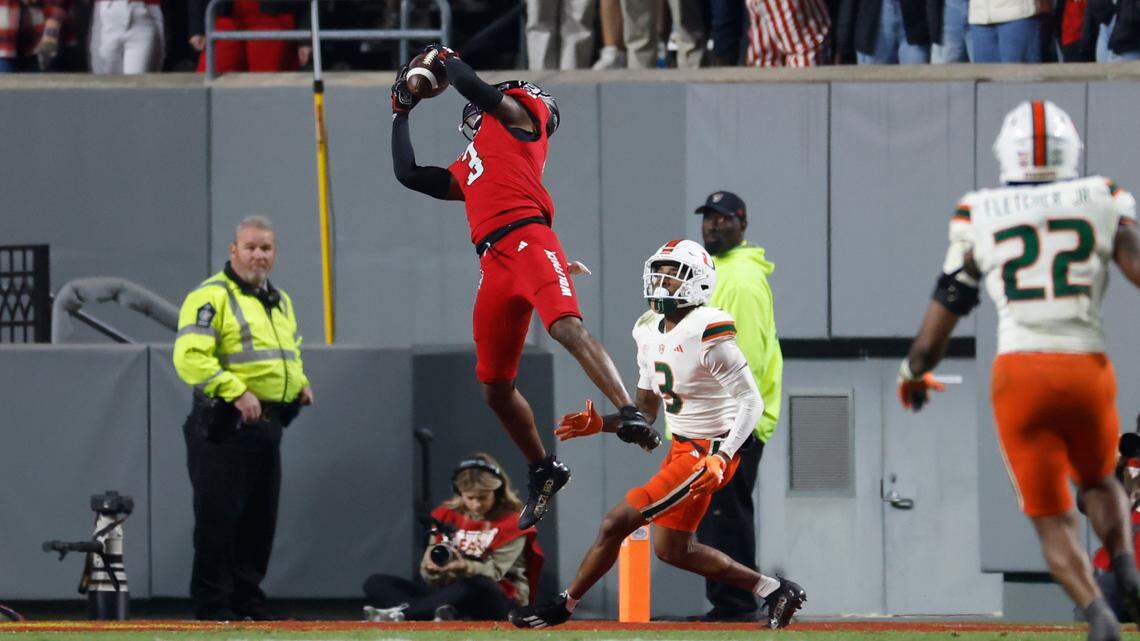 N.C. State cornerback Aydan White (3) intercepts a ball intended for Miami wide receiver Jacolby George (3) during the first half of N.C. State’s game against Miami at Carter-Finley Stadium in Raleigh, N.C., Saturday, Nov. 4, 2023.