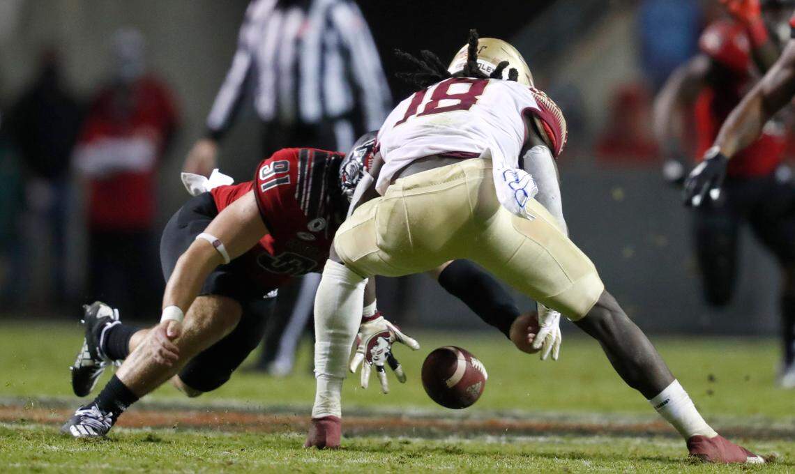 N.C. State’s Joe Shimko (91) and Florida State’s Travis Jay (18) go for the ball after Jay fumbled it during the second half of N.C. State’s 38-22 victory over Florida State at Carter-Finley Stadium in Raleigh, N.C., Saturday, Nov. 14, 2020. N.C. State would recover the fumble.