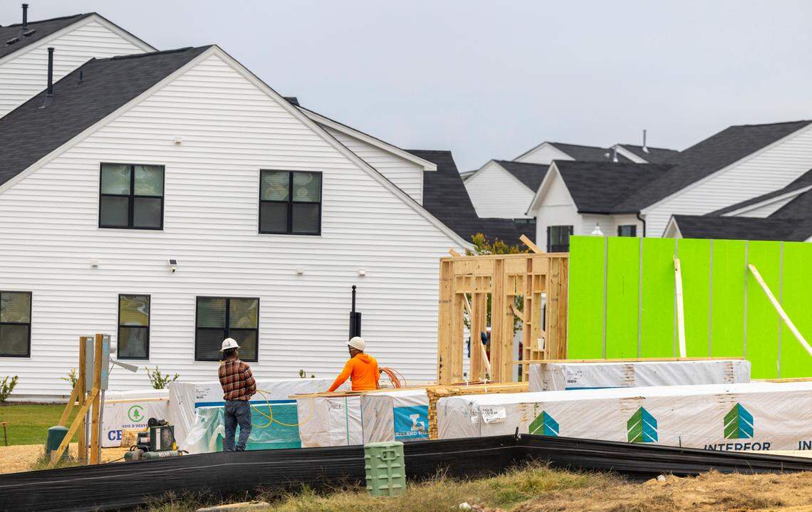 Construction workers build townhomes in the Barrington subdivision, outside Zebulon.