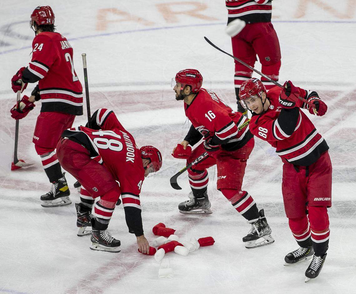 Carolina Hurricanes’ Martin Necas (88) launches t-shirts off his stick to fans following the Hurricanes’ 6-3 victory over New Jersey on Thursday, April 28, 2022 at PNC Arena in Raleigh, N.C.