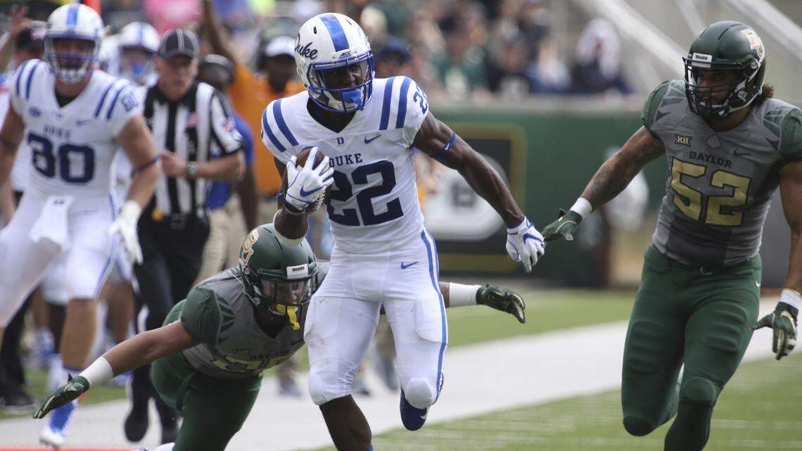 Duke running back Brittain Brown (22) runs down field ahead of Baylor linebacker Terrel Bernard, left, and defensive end Greg Roberts, right, on Saturday.