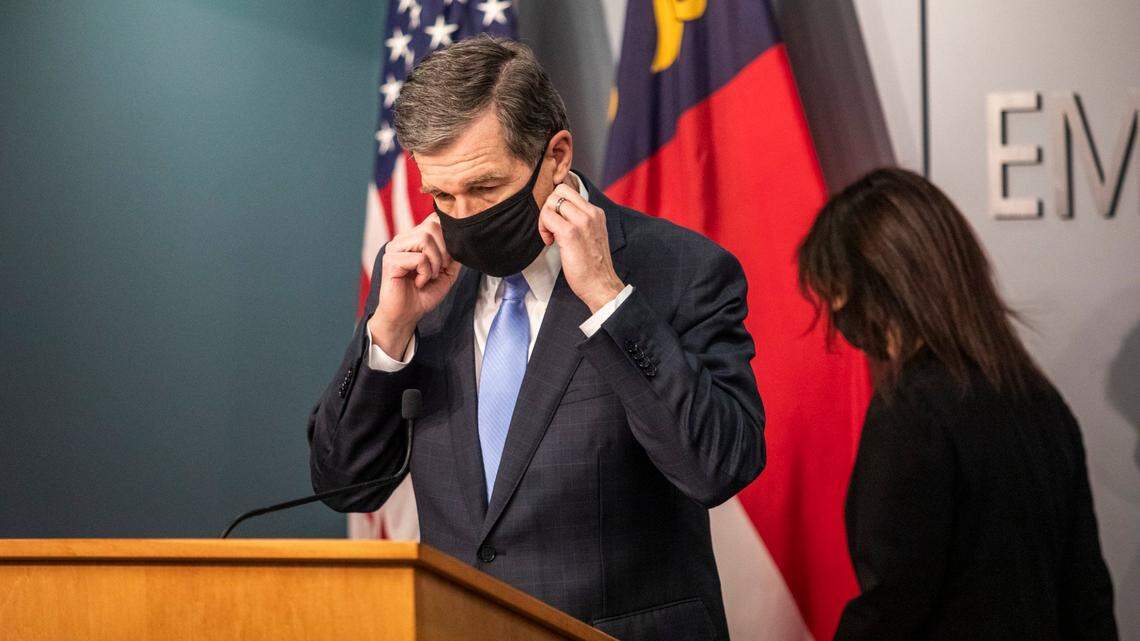 Gov. Roy Cooper removes his mask before speaking during a briefing on North Carolina’s coronavirus pandemic response Tuesday, Jan. 12, 2021 at the NC Emergency Operations Center in Raleigh.