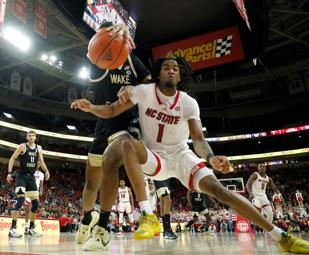 Wake Forest’s Efton Reid III and N.C. State’s Jayden Taylor chase after a loose ball during the second half of the Wolfpack’s 83-76 win at PNC Arena on Tuesday, Jan. 16, 2024, in Raleigh, N.C.
