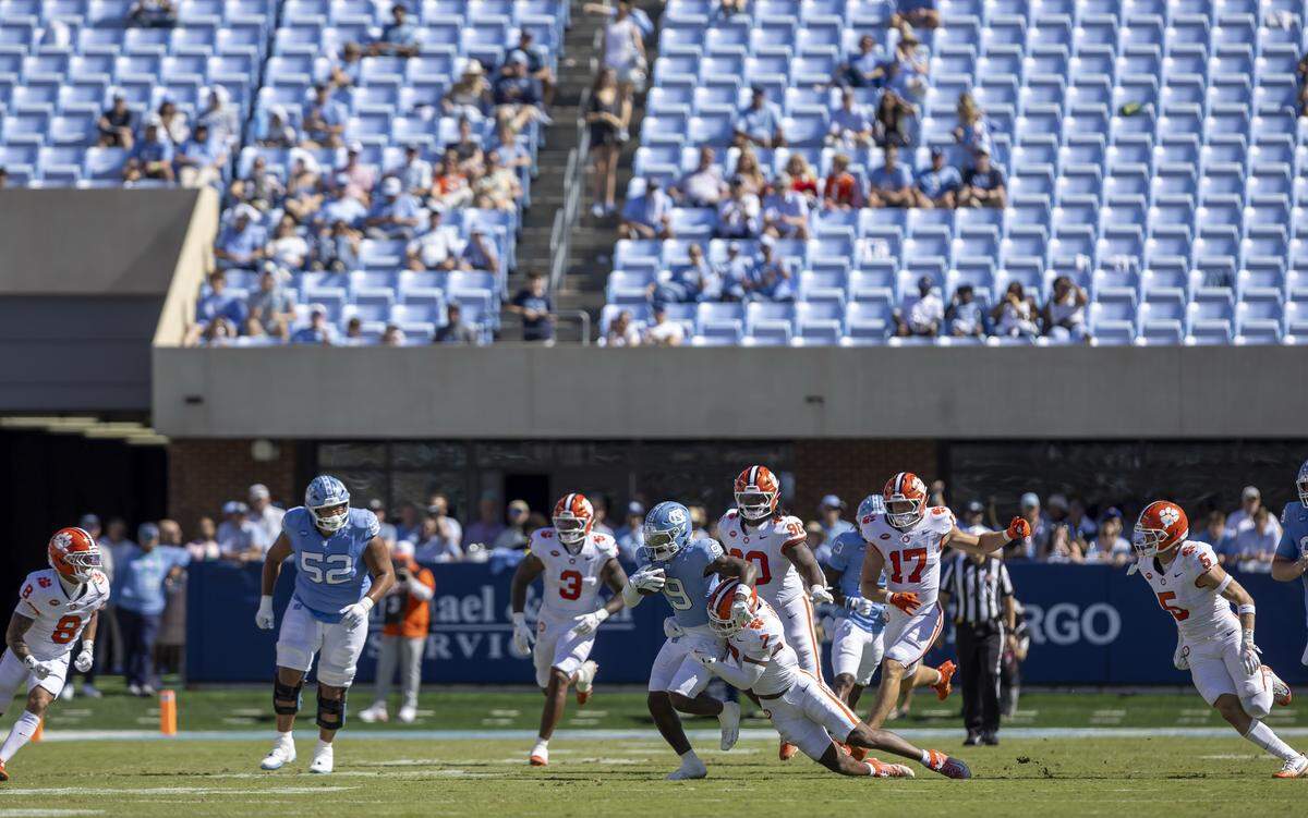 With most of the Blue Zone empty in the third quarter, Clemson safety Khalil Barnes (7) stops North Carolina wide receiver Javarius Green (9) on Saturday, October 4, 2025 at Kenan Stadium in Chapel Hill, N.C. 