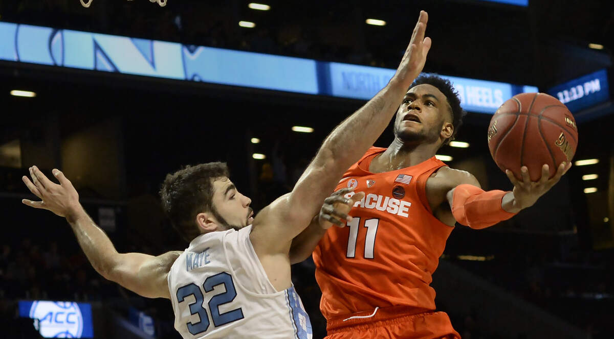 UNC forward Luke Maye (32) defends as Syracuse forward Oshae Brissett (11) moves inside in the second half.