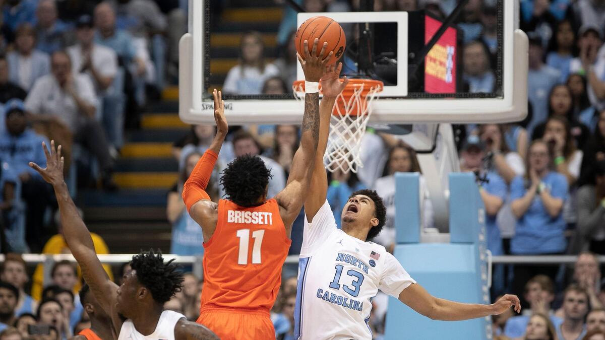 North Carolina’s Cameron Johnson (13) blocks a shot by Syracuse’s Oshae Brissett (11) during the first half on Tuesday, February 26, 2019 at the Smith Center in Chapel Hill, N.C.
