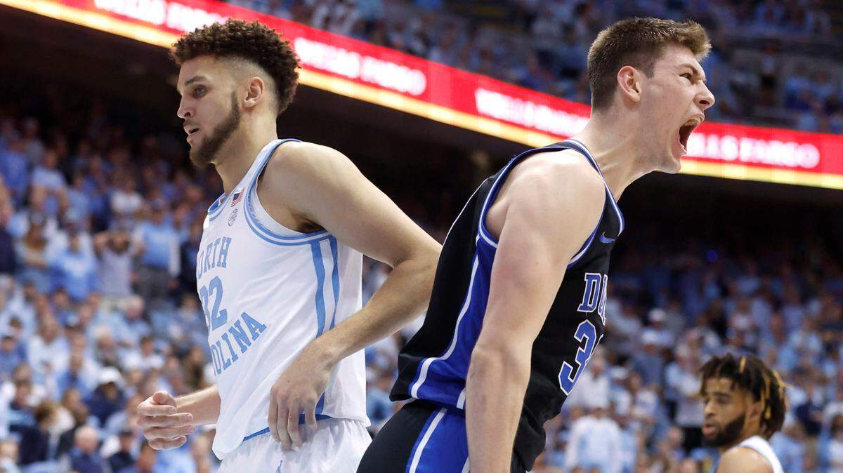Duke’s Kyle Filipowski (30) celebrates making the dunk as he passes North Carolina’s Pete Nance (32) during the second half of Duke’s 62-57 victory over UNC at the Smith Center in Chapel Hill, N.C., Saturday, March 4, 2023.