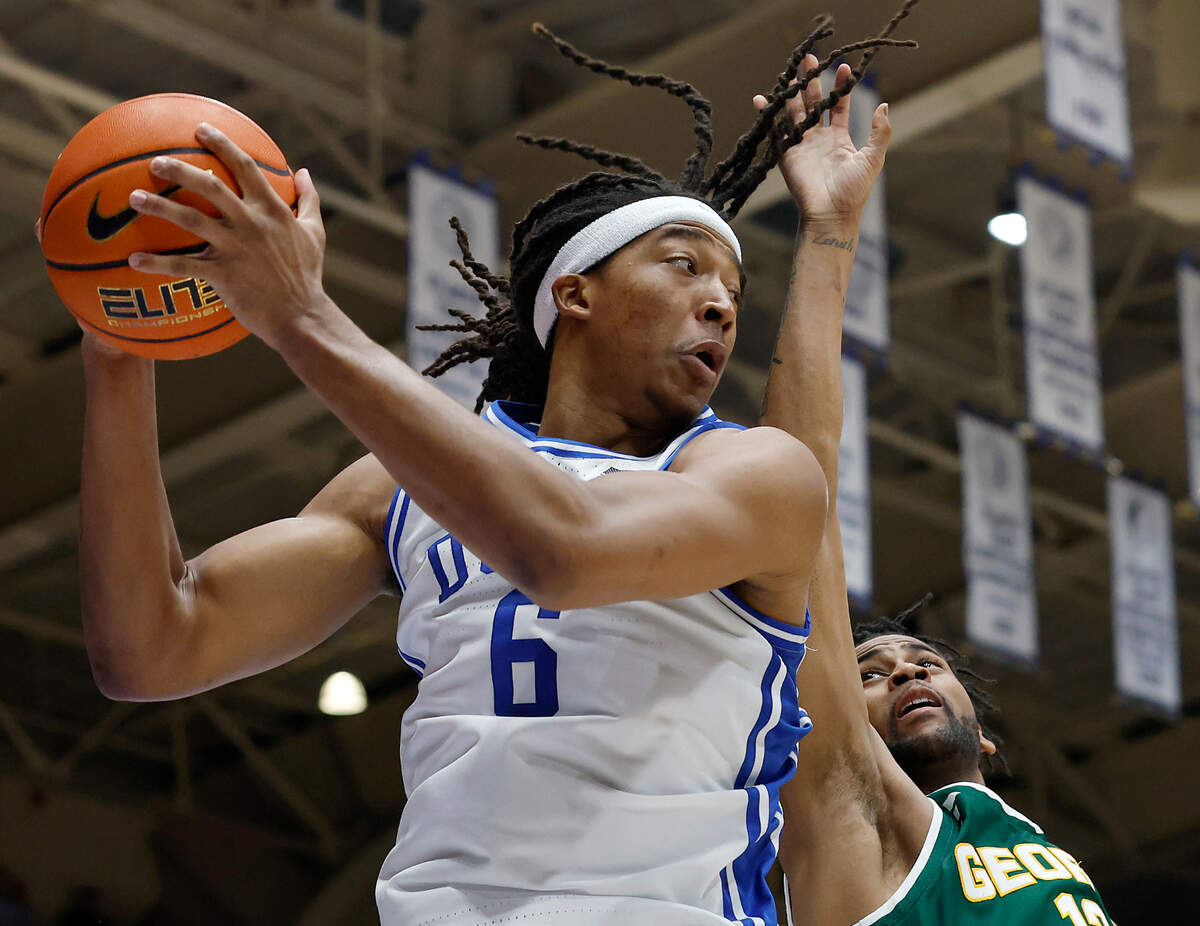Duke’s Maliq Brown grabs a rebound over George Mason’s Darius Maddox during the second half of the Blue Devils’ 68-47 win on Tuesday, Dec. 17, 2024, at Cameron Indoor Stadium in Durham, N.C.