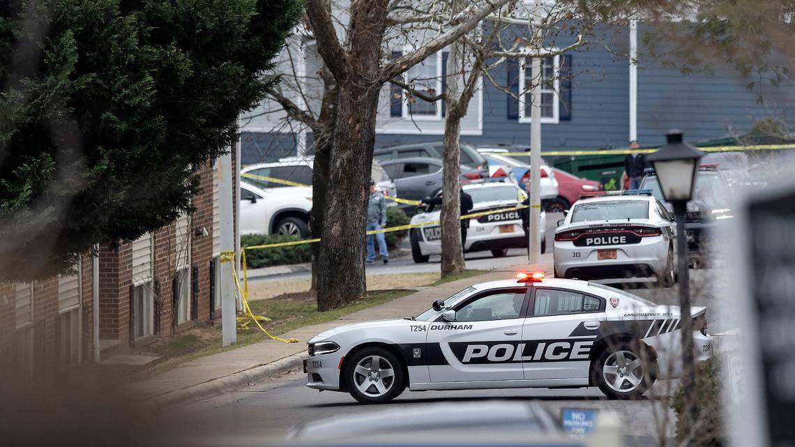 Law enforcement vehicles block a section of a parking lot at Duke Manor apartments off of LaSalle Street following a shooting on Thursday, Jan. 12, 2023, in Durham, N.C.