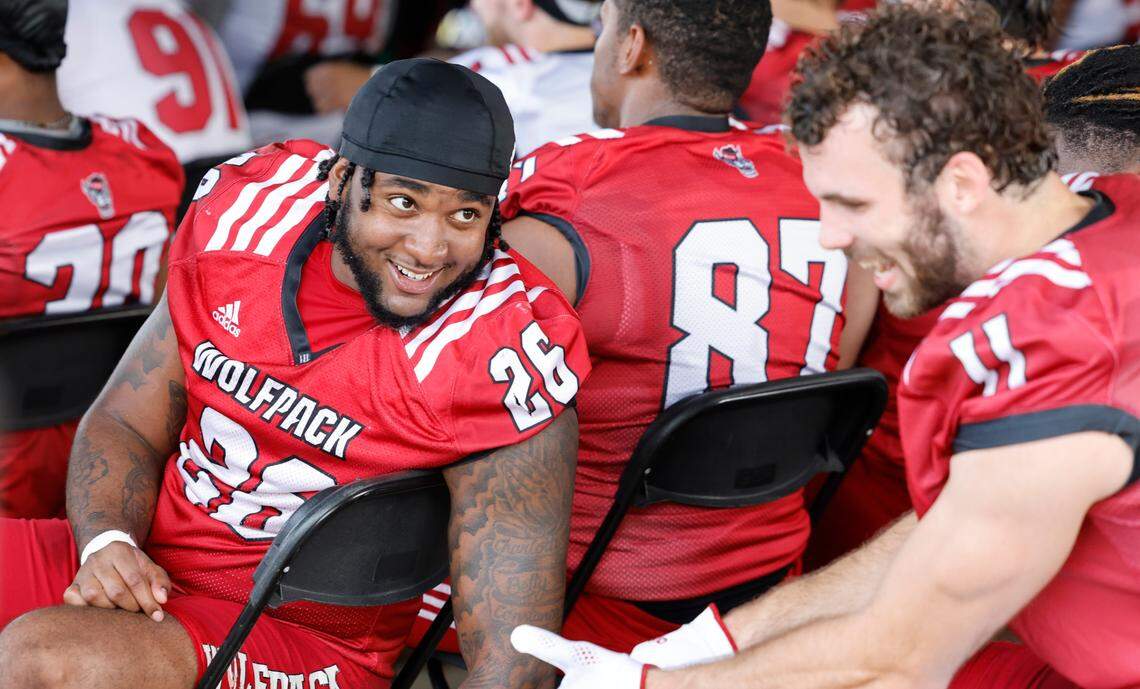 N.C. State linebacker Devon Betty (26) laughs with linebacker Payton Wilson (11) during a break during the Wolfpack’s first fall practice in Raleigh, N.C., Wednesday, August 2, 2023.
