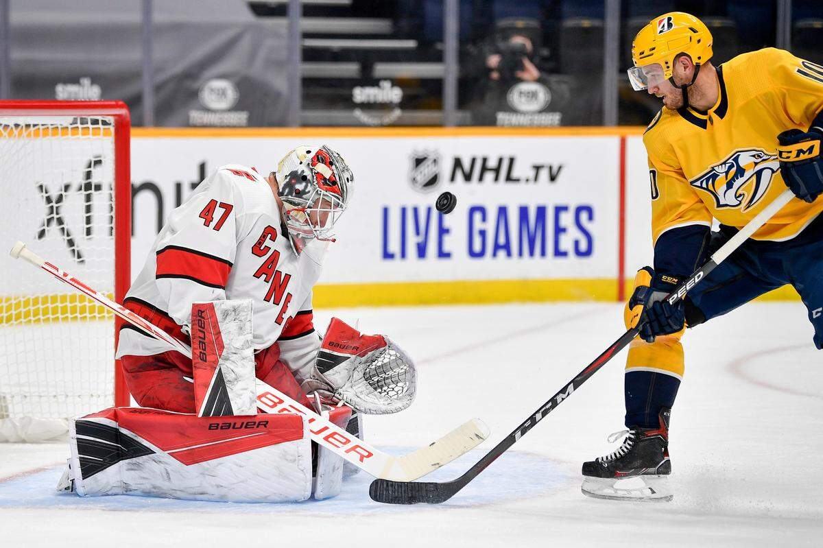 Carolina Hurricanes goaltender James Reimer (47) deflects a shot from Nashville Predators center Colton Sissons (10) during the first period of an NHL hockey game in Nashville, Tenn., Monday, Jan. 18, 2021. (Andrew Nelles/The Tennessean via AP)