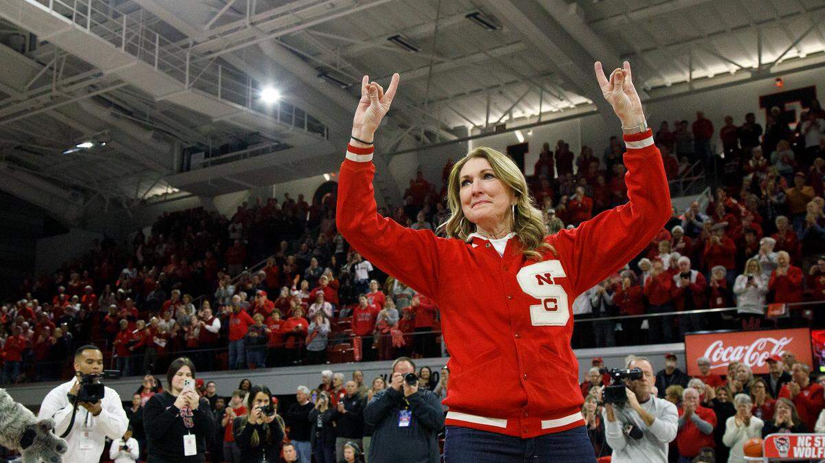 Debbie Antonelli, broadcaster and former N.C. State women’s basketball player, acknowledges the crowd as she is honored during a halftime ceremony of the Wolfpack’s game against Pittsburgh on Thursday, Jan. 16, 2025, at Reynolds Coliseum in Raleigh, N.C. The Wolfpack added Antonelli to its women’s basketball Ring of Honor for her playing career, broadcast career and philanthropic contributions to the program.