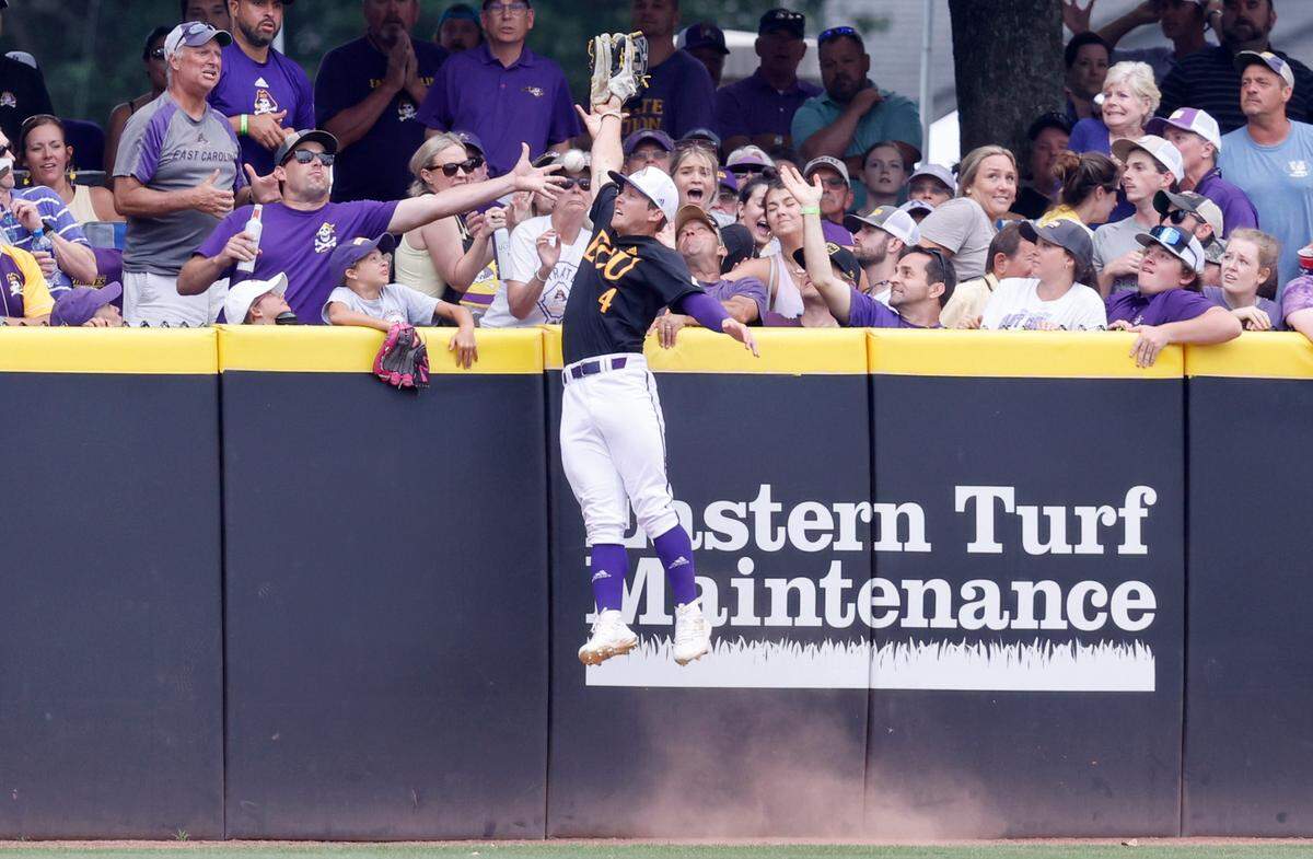 East Carolina’s Lane Hoover (4) can’t pull in a three-run homerun by Texas’ Ivan Melendez in the first inning during ECU’s game against Texas in the Greenville Super Regional at Clark-LeClair Stadium Sunday, June 12, 2022.