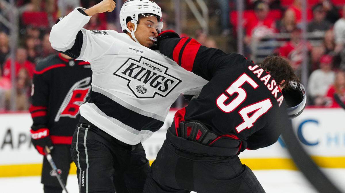 Carolina Hurricanes left wing Juha Jaaska (54) fights Los Angeles Kings center Akil Thomas (26) during the first period at Lenovo Center.