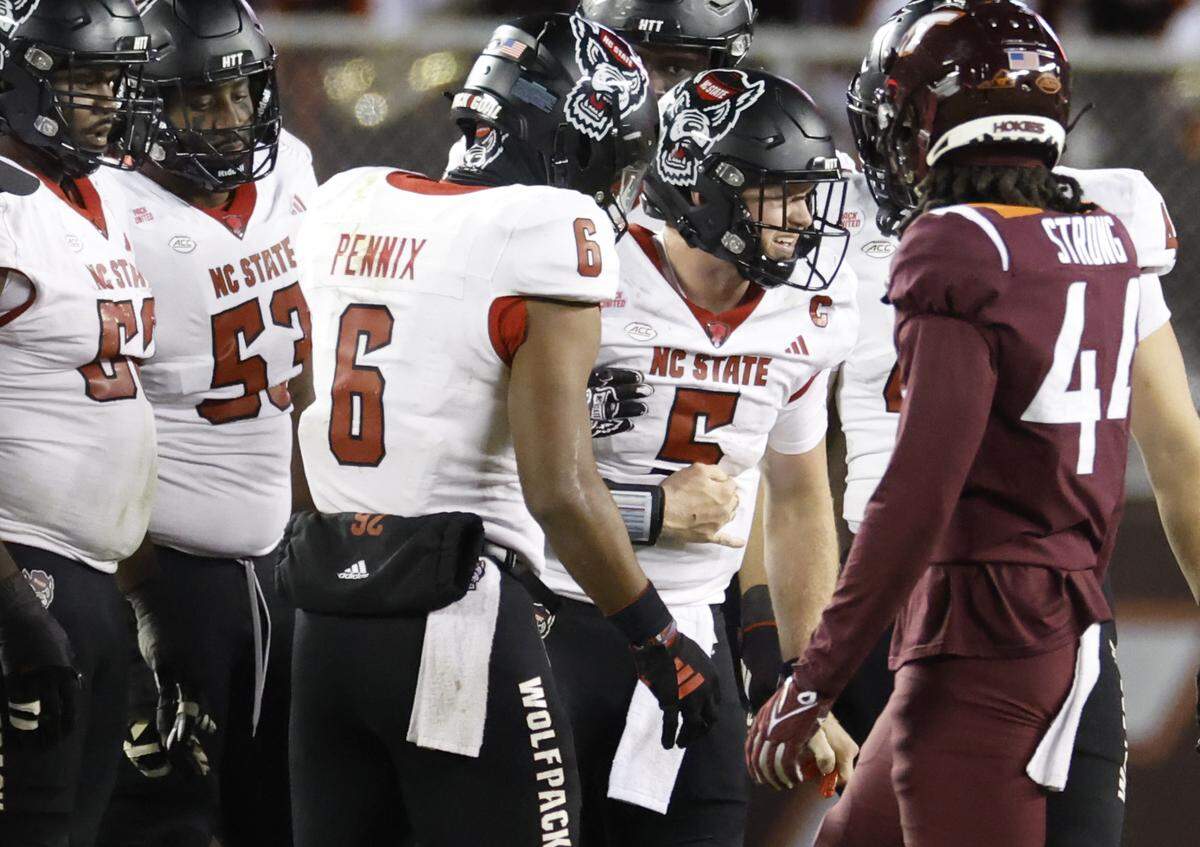 N.C. State quarterback Brennan Armstrong (5) winces in pain after being hit hard during the second half of N.C. State’s 35-28 victory over Virginia Tech at Lane Stadium in Blacksburg, VA, Saturday, Nov. 18, 2023.