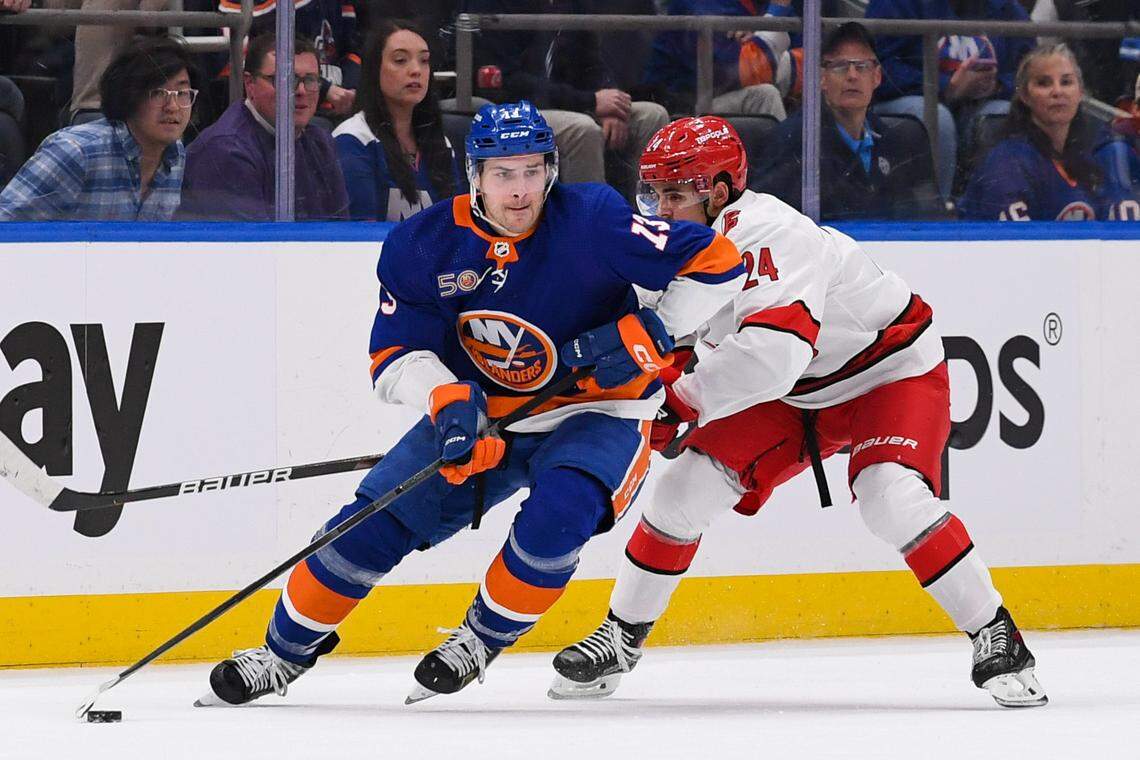 New York Islanders center Mathew Barzal (13) skates with the puck defended by Carolina Hurricanes center Seth Jarvis (24) during the first period in game three of the first round of the 2023 Stanley Cup Playoffs at UBS Arena.