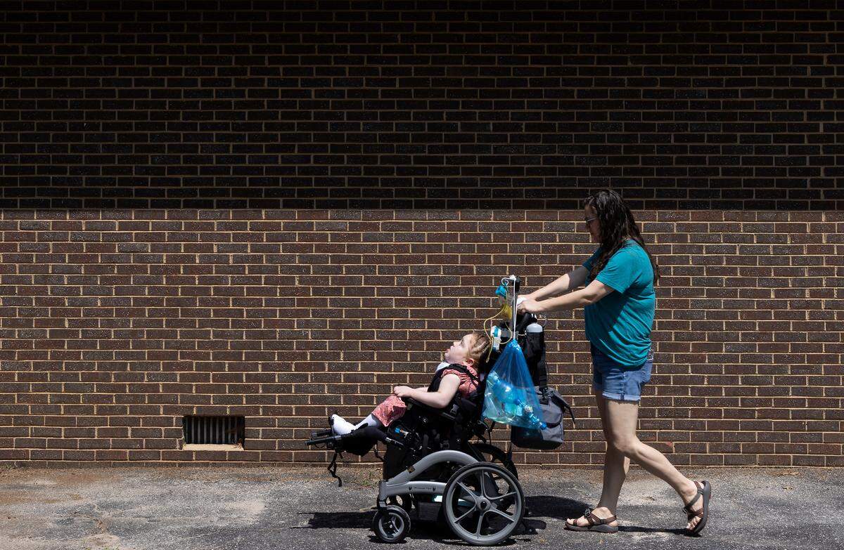 Jennifer Emerson walks with her daughter, Evangeline, 8, outside their home in Raleigh, N.C. on Thursday, July 13, 2023. Emerson and her husband bought the home using Ownify, a fractional homeownership program.