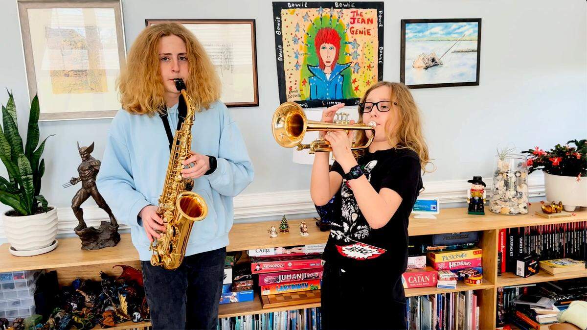 River (left) and Jet Collins play “I Wish That We Never Met” by Ariel Posen.  The image is from a video posted by their father.