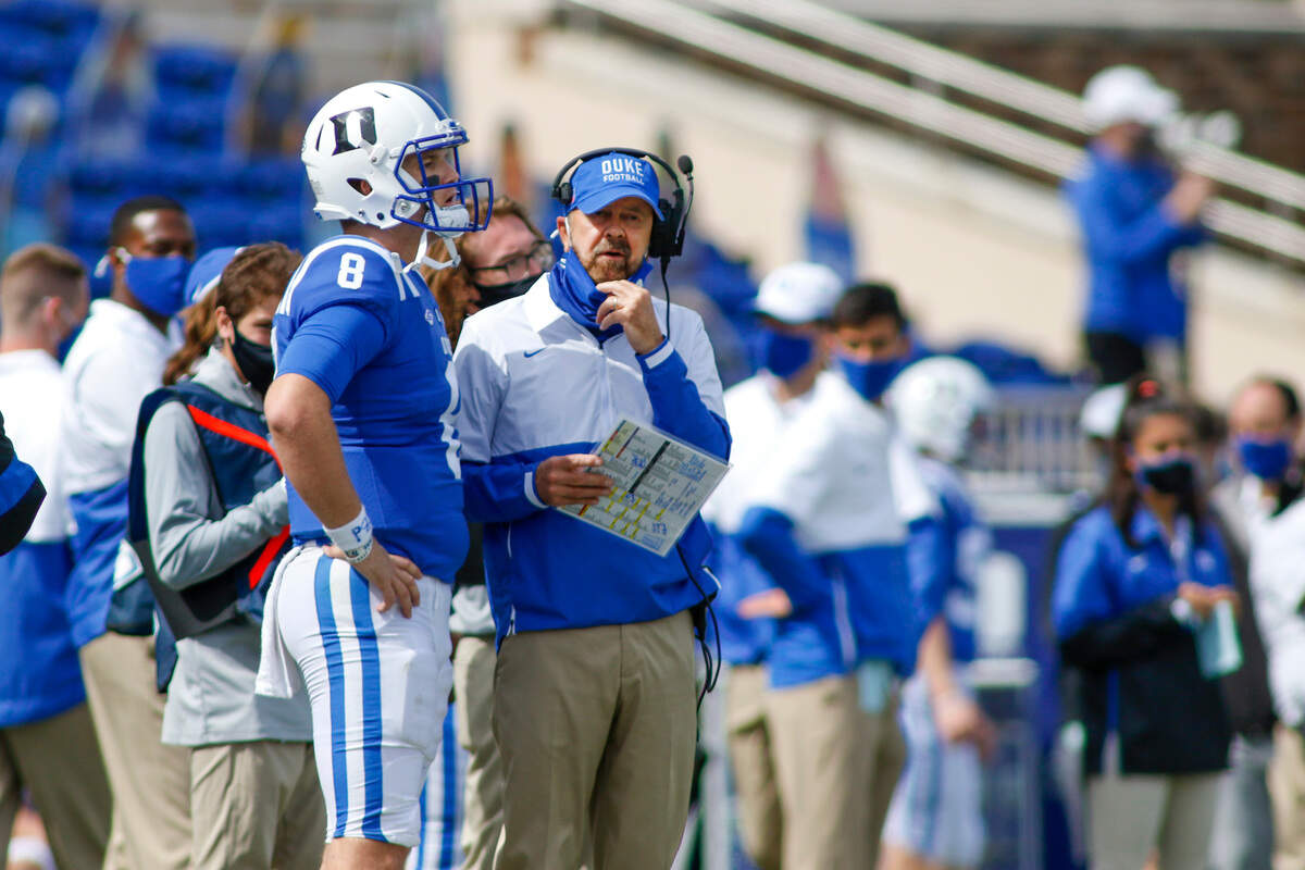 Duke Blue Devils head coach David Cutcliffe talks to Duke Blue Devils quarterback Chase Brice after Brice threw an interception in the fourth quarter against the Boston College Eagles at Wallace Wade Stadium. The Boston College Eagles won 26-6.