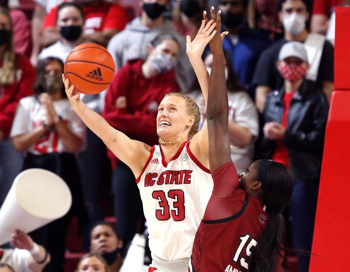 N.C. State’s Elissa Cunane (33) shoots as South Carolina’s Victaria Saxton (5) defends during the first half of N.C. States game against South Carolina at Reynolds Coliseum in Raleigh, N.C., Tuesday, November 9, 2021.