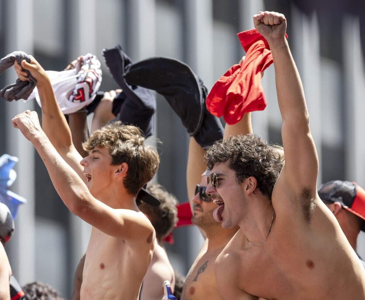 Shirtless fans acknowledge shirtless members of the Stanley Cup Champion Carolina Hurricanes, as they make their way down Fayetteville Street, during their parade on Saturday, June 20, 2026 in Raleigh, NC.