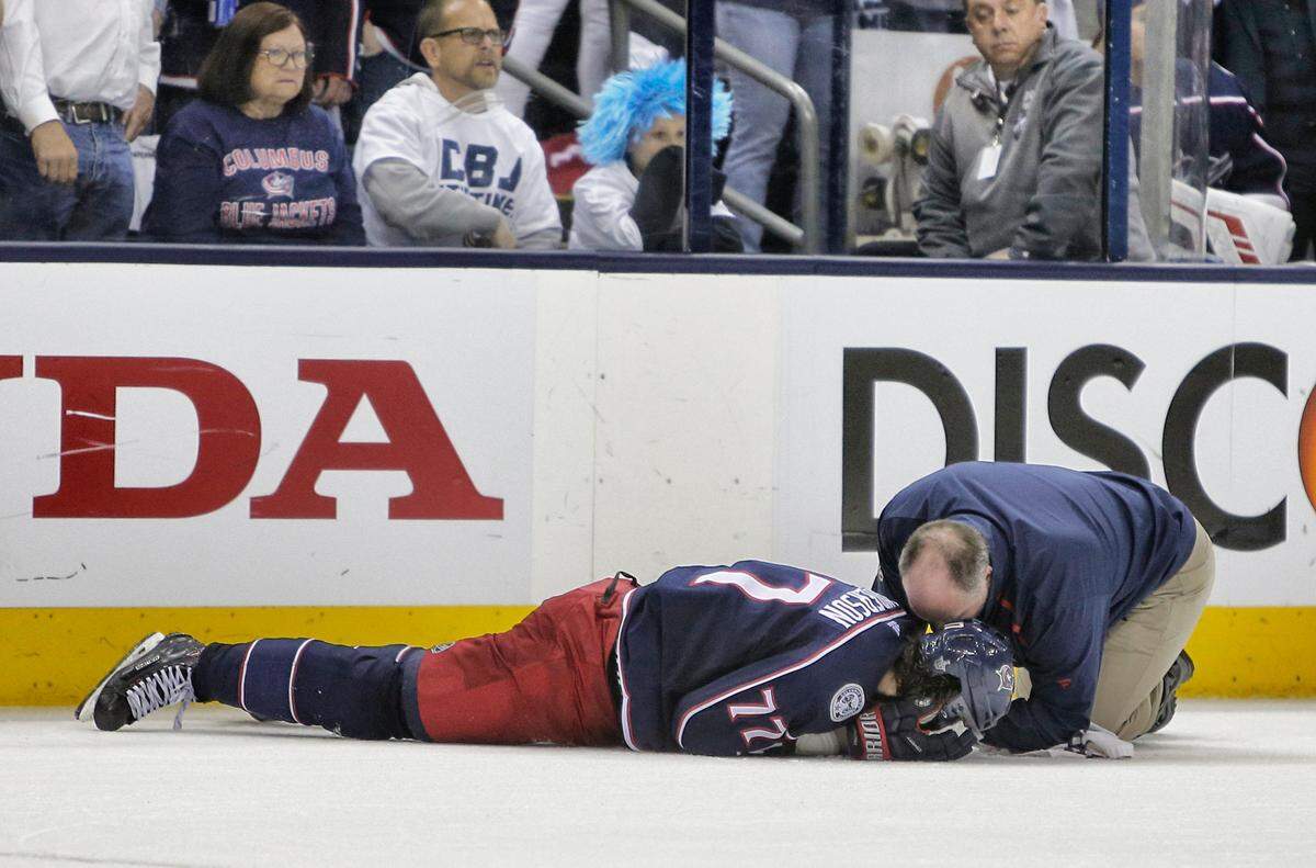 Columbus Blue Jackets athletic trainer Mike Vogt, right, tends to Josh Anderson after he was hit by Boston Bruins’ Charlie McAvoy during the second period of Game 6 of an NHL hockey second-round playoff series Monday, May 6, 2019, in Columbus, Ohio.