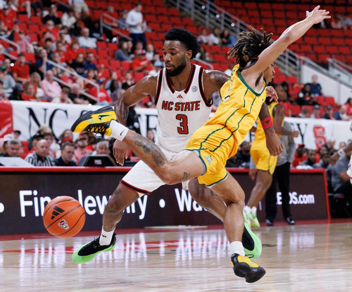 N.C. State’s Dontrez Styles fouls Lees-McRae’s Dre Jackson during the first half of the Wolfpack’s 79-75 exhibition win on Wednesday, Oct. 30, 2024, at the Lenovo Center.