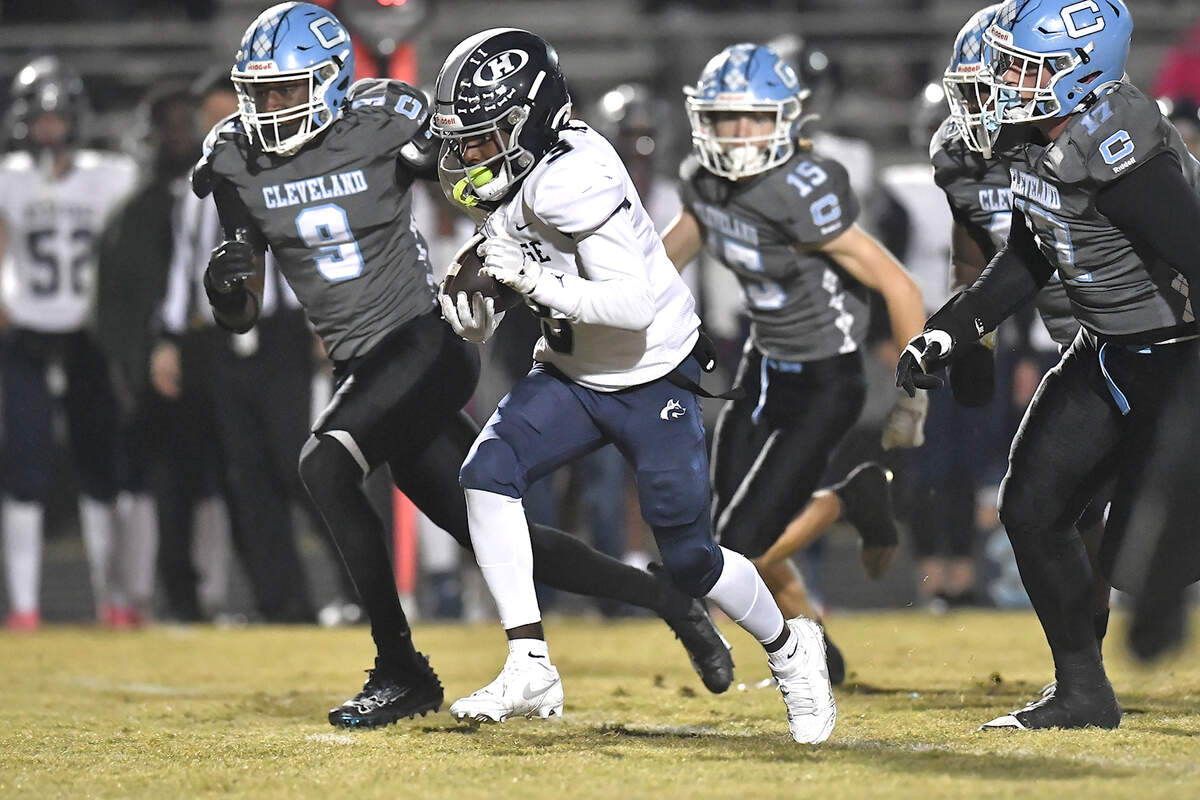 Heritage running back LaDainian Person (3) runs for the first down ahead of the Cleveland defense during the first half. The Cleveland Rams and the Heritage Huskies met in the first round of the NCHSAA 4A playoffs in Clayton, N.C. on November 15, 2024.