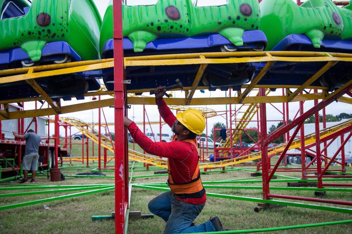 Workers assemble the Wacky Worm ride Tuesday, Oct. 12, 2021 at the NC State Fair in Raleigh. The North Carolina fair opens on Thursday and inspectors with the labor department must insure nearly 100 rides meet safety standards.