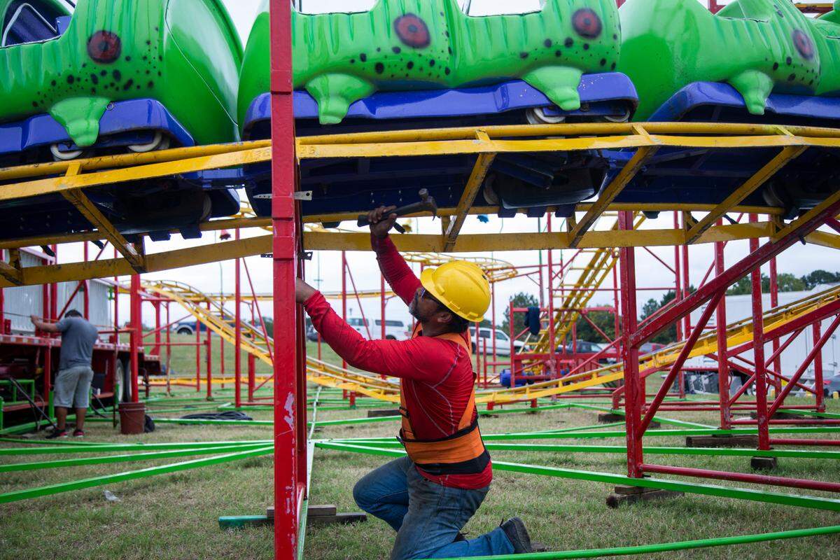 Workers assemble the Wacky Worm ride Tuesday, Oct. 12, 2021 at the NC State Fair in Raleigh. The North Carolina fair opens on Thursday and inspectors with the labor department must insure nearly 100 rides meet safety standards.
