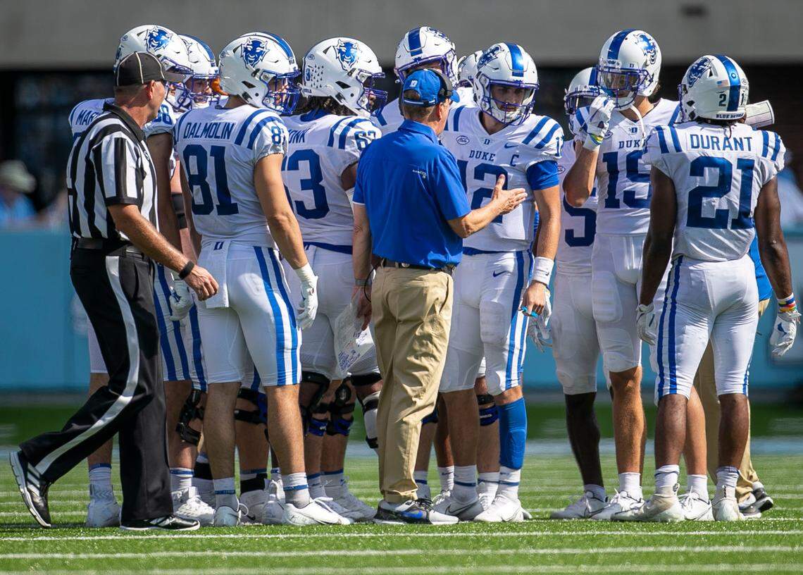 Duke coach David Cutcliffe confers with quarterback Gunnar Holmberg (12) in the fourth quarter against North Carolina on Saturday, October 2, 2021 at Kenan Stadium in Chapel Hill, N.C.