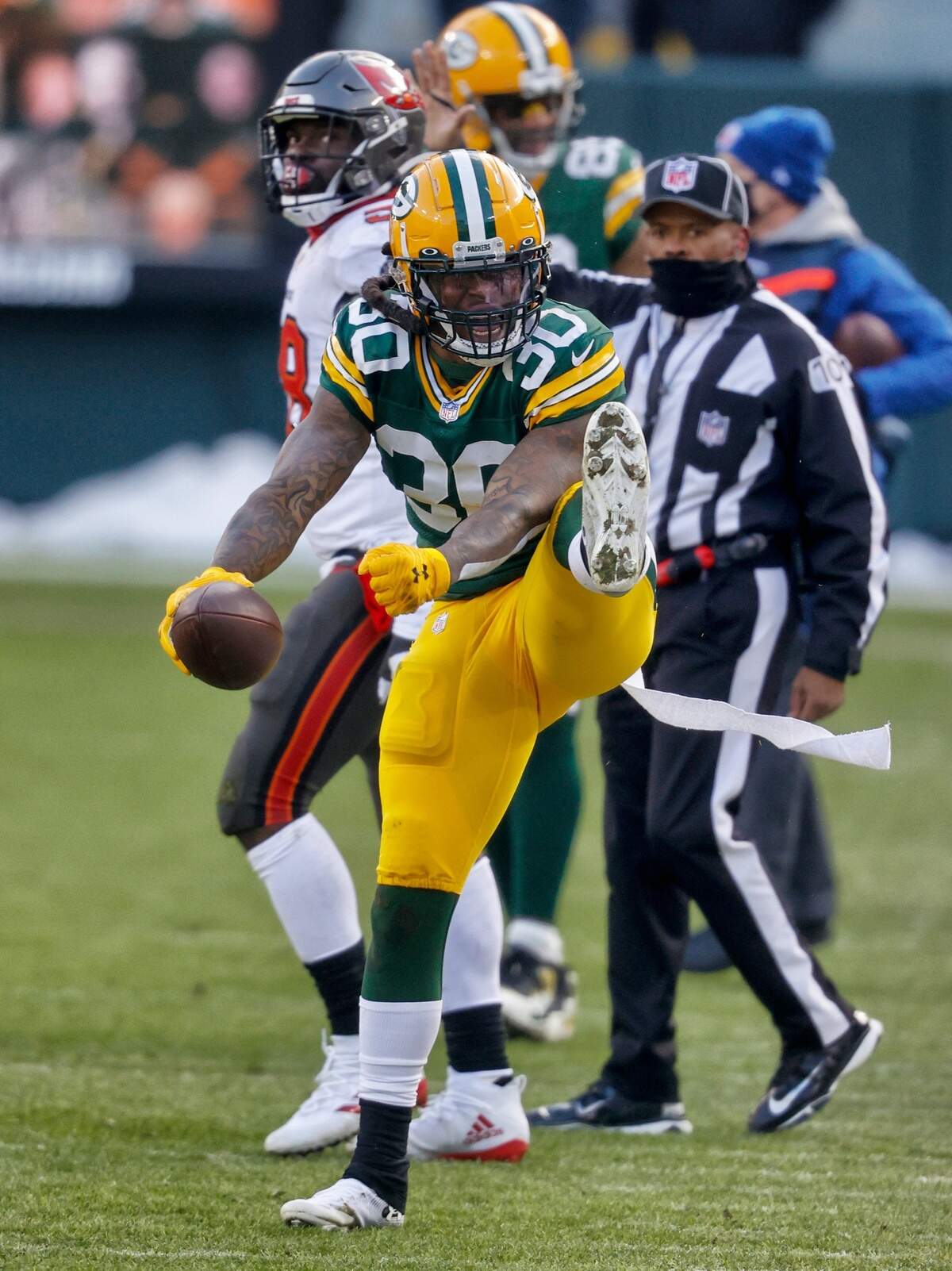 Green Bay Packers’ Jamaal Williams (30) celebrates during the first half of the NFC championship NFL football game against the Tampa Bay Buccaneers in Green Bay, Wis., Sunday, Jan. 24, 2021.