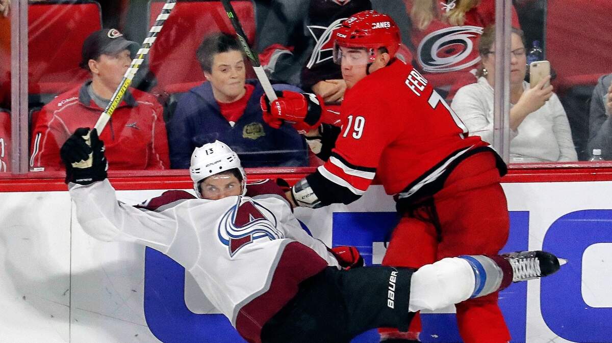 Carolina Hurricanes’ Micheal Ferland (79) checks Colorado Avalanche’s Alexander Kerfoot (13) during the third period.
