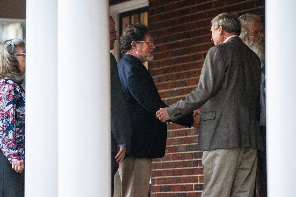State Reps. Larry Pittman and Michael Speciale are greeted during a reception at the United Daughters of the Confederacy house in downtown Raleigh on Tuesday night, Feb. 5, 2019. The reception sponsored by the North Carolina Division Sons of Confederate Veterans and the protest come during the ongoing debate over Confederate monuments on public property.