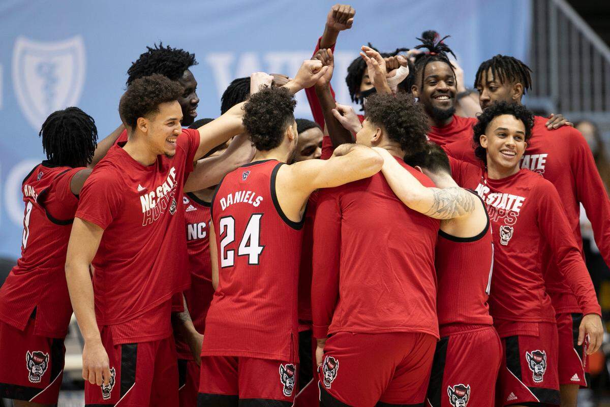 N.C. State’s Devon Daniels (24) huddles with his teammates prior to their game against North Carolina on Saturday, January 23, 2021 at the Smith Center in Chapel Hill, NC.