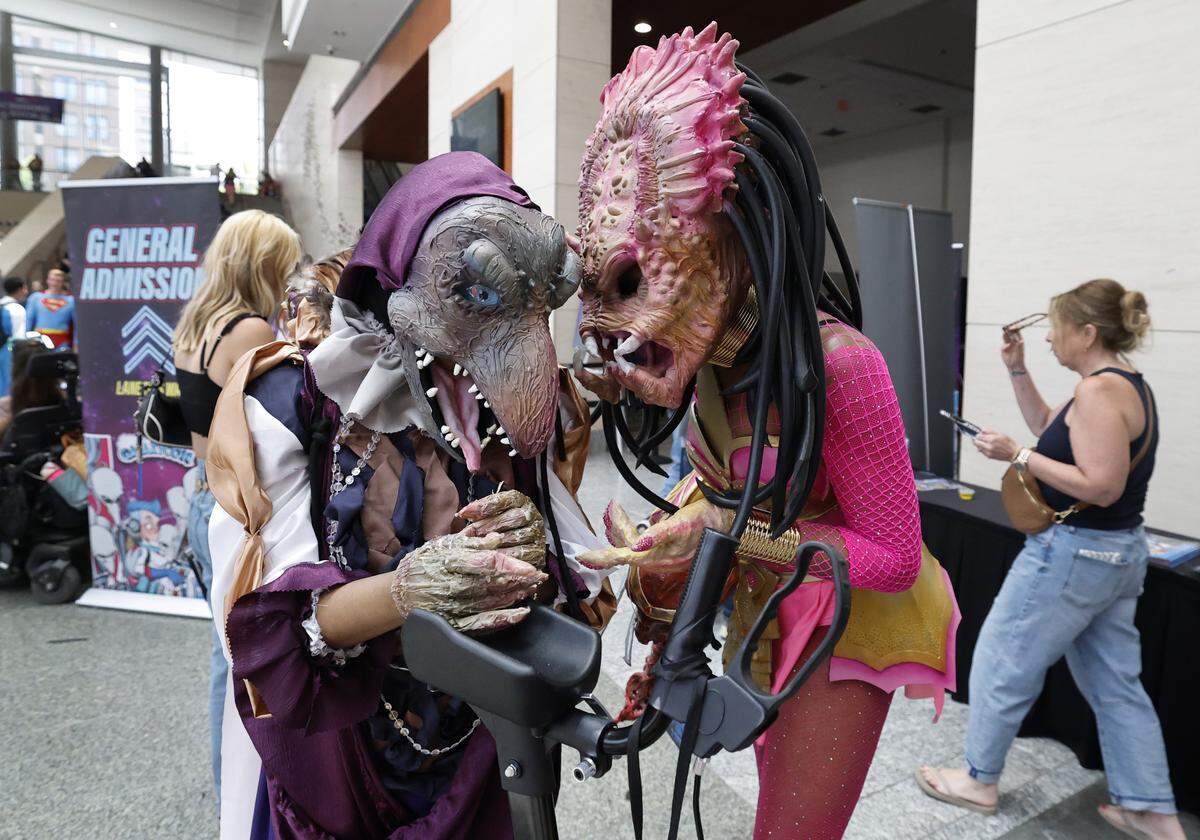 Dani Gosha of Goldsboro, right, talks with her twin sister Gabi Gosha during GalaxyCon Raleigh at the Raleigh Convention Center Saturday, July 26, 2025. Dani is Princess Predator and Gabi is Skeksis from Dark Crystal. 