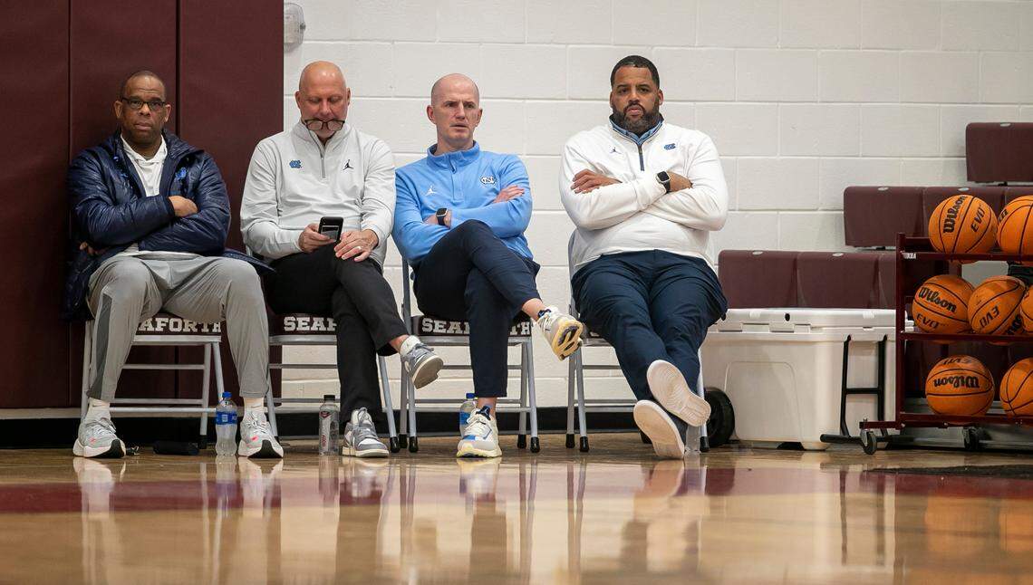 University of North Carolina coaches Hubert Davis, Jeff Lebo, Brad Frederick and Sean May watch Jarin Stevenson (15) play during a victory over Jordan-Matthews on January 31, 2023 in Pittsboro, N.C.