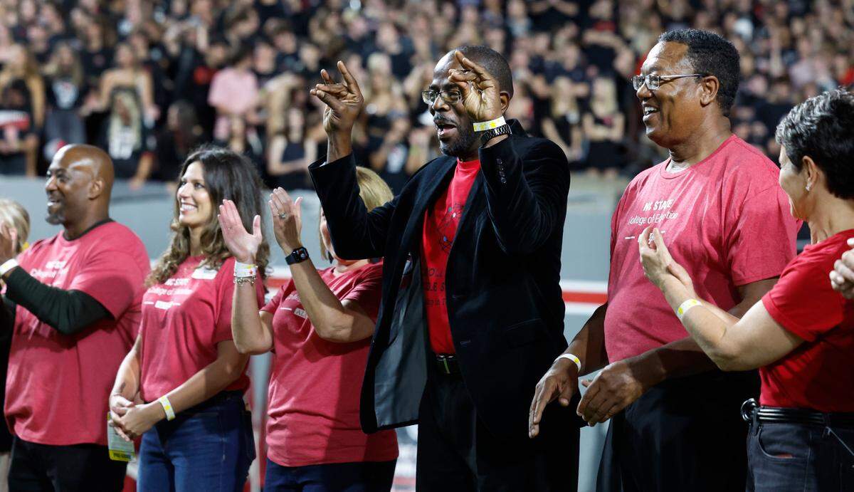 New Wake County Superintendent Robert Taylor acknowledges the crowd as he is introduced along with other teachers and administrators during N.C. State’s football game against Louisville at Carter-Finley Stadium in Raleigh, N.C., Friday, Sept. 29, 2023. It was educator appreciation day at the game.