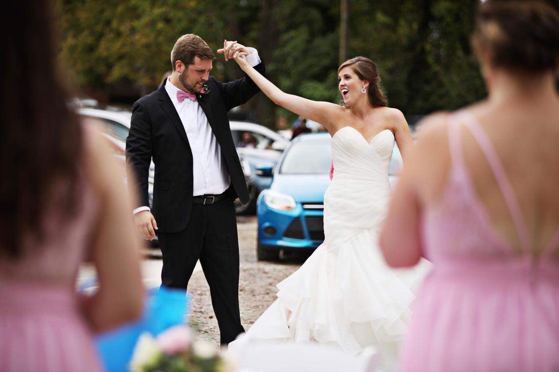 Carrie and John Michael Simpson, take their first dance as they are serenaded by a friend on Zoom after their wedding ceremony on Sunday, Sept. 27, 2020, in Youngsville. The couple decided to have their ceremony in the parking lot of the Victorian House so that they could invite more guests who could watch from their cars. They also live-streamed the wedding for others who couldn’t attend in person.