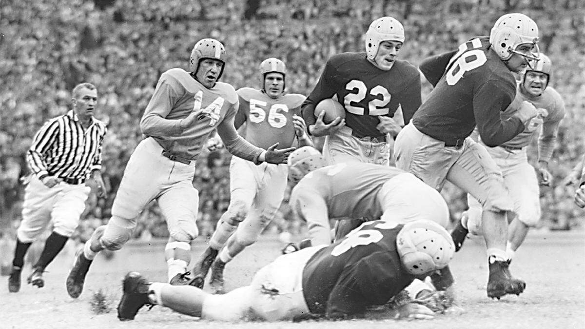 Charlie Justice (22) follows the interference supplied by Carolina tackle Heywood Fowle (58) for a good gain against Tennessee in Kenan stadium circa 1948.