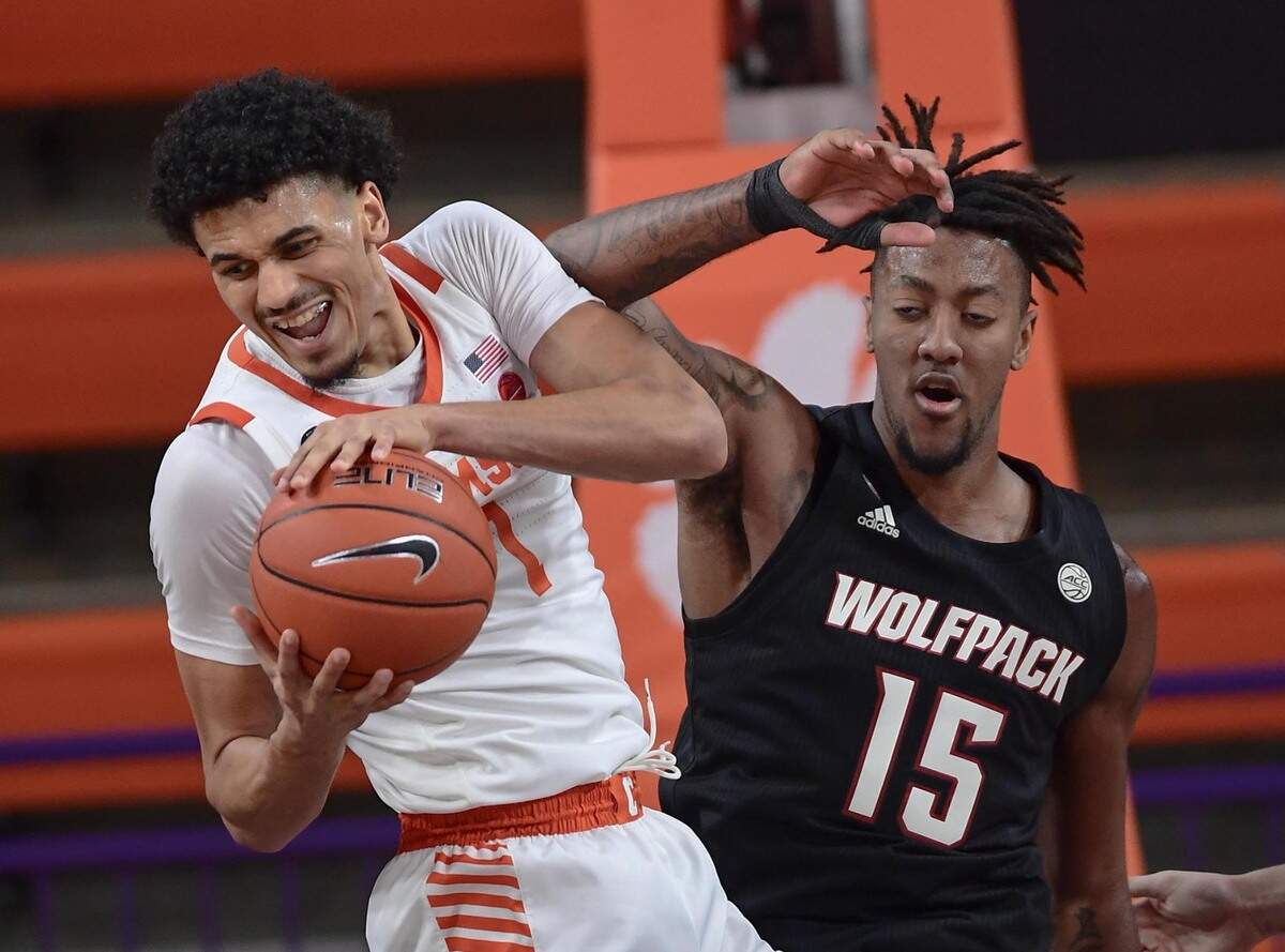 Clemson senior forward Jonathan Baehre (1) rebounds near NC State forward Manny Bates(15) January 5, 2021.