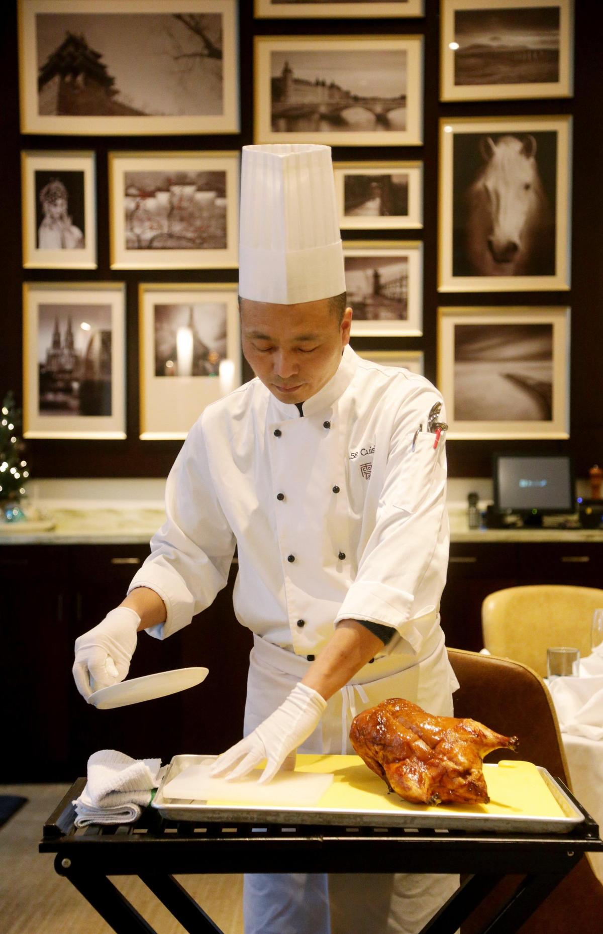 Chef Hong Bao Wang prepares to slice the Peking duck at G.58 Cuisine in Morrisville on Monday, Dec. 10, 2018.