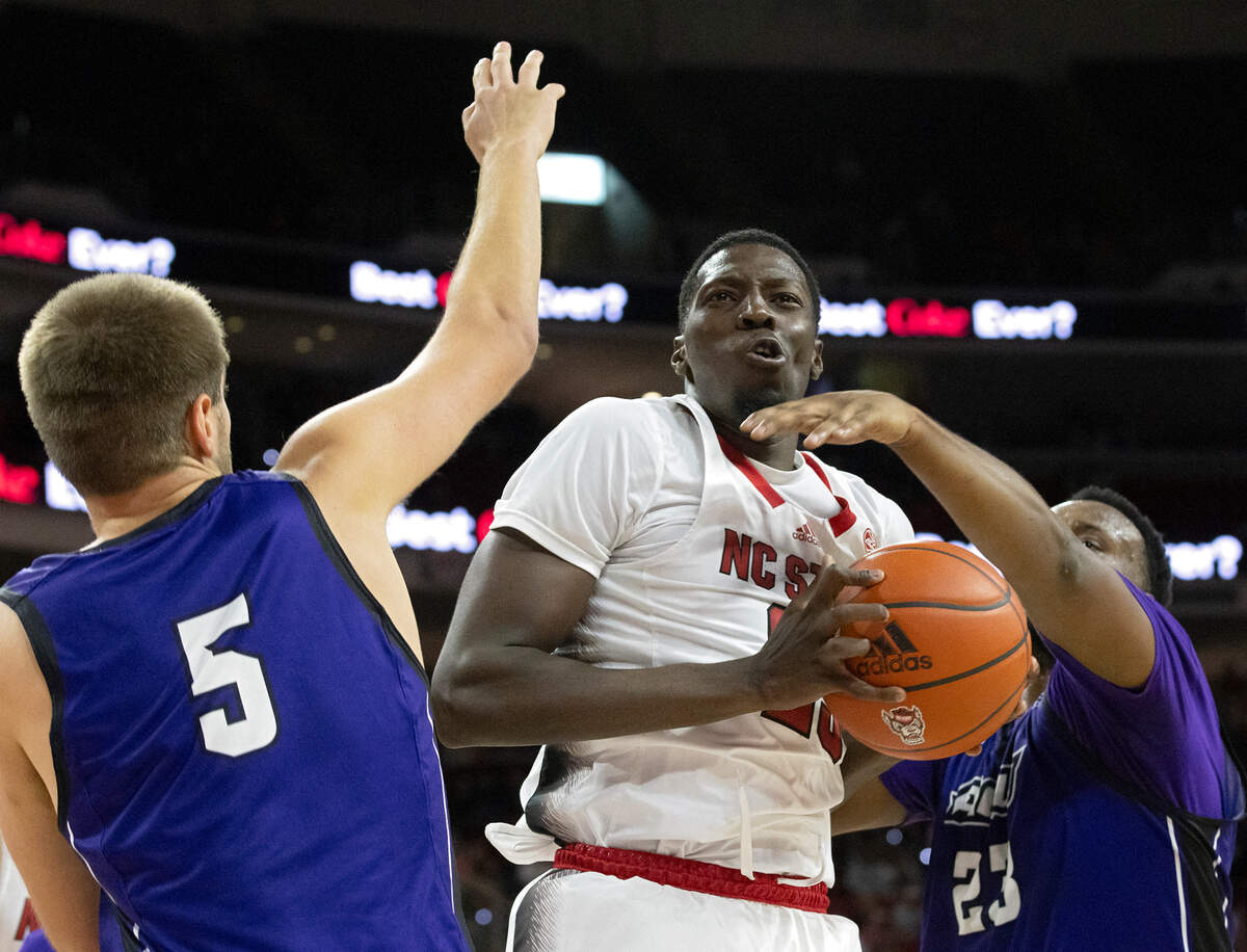 N.C. State’s Mohamed Diarra is fouled as he pulls down a rebound away from Abilene Christian’s Cameron Steele and Airion Simmons during the first half of the Wolfpack’s 84-64 win on Friday, Nov. 10, 2023, at PNC Arena in Raleigh, N.C.