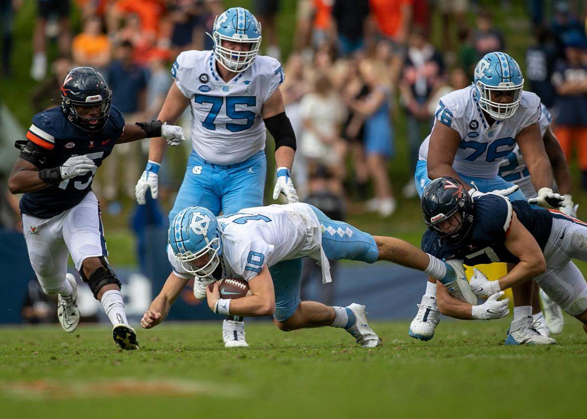 Virginia’s James Jackson (9) stops North Carolina quarterback Drake Maye (10) after a three-yard gain in the third quarter on Saturday, November 5, 2022 at Scott Stadium in Charlottesville, Va