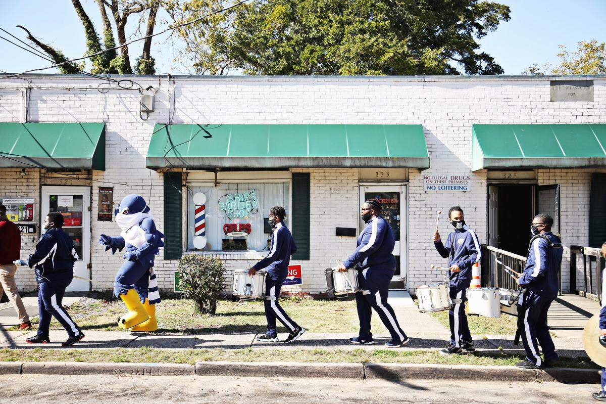 Saint Augustine’s University students are led by the marching band to the polls at Tarboro Road Community Center in Raleigh, Tuesday, Nov. 3, 2020.