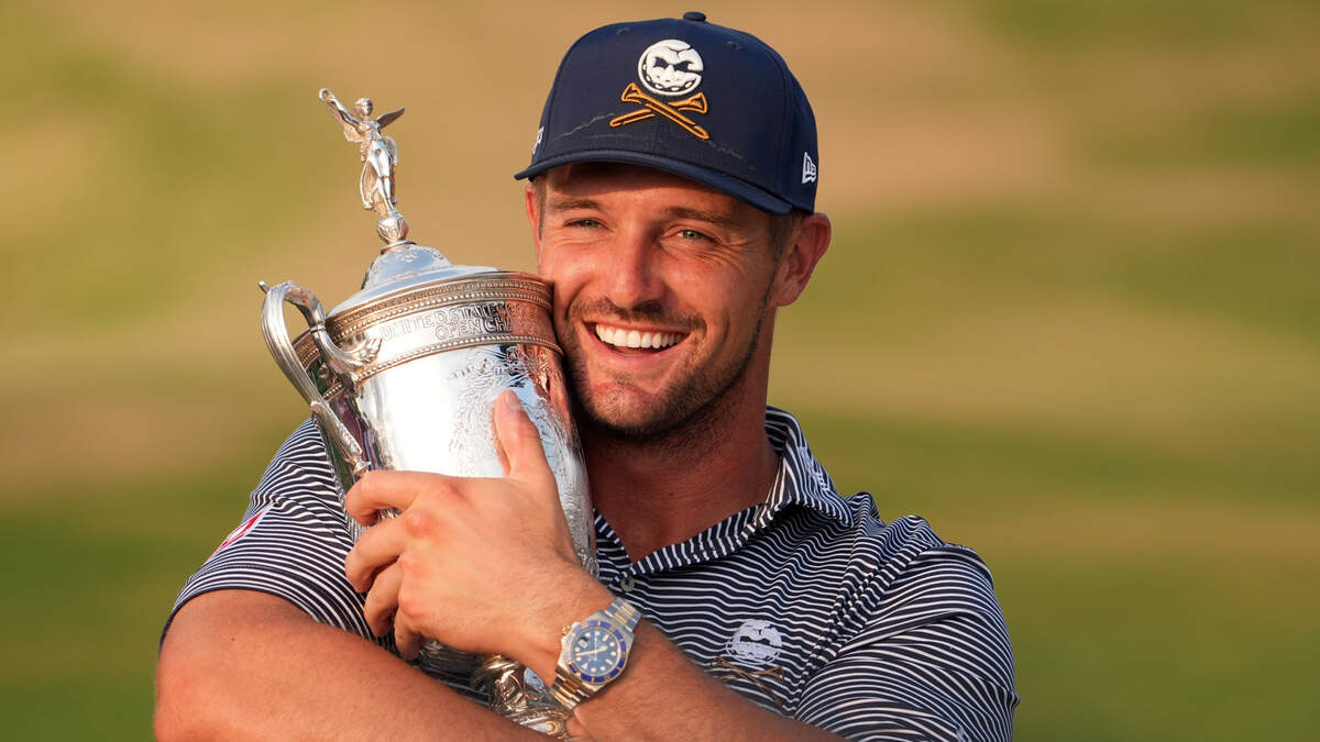 Bryson DeChambeau celebrates with the trophy after winning the U.S. Open golf tournament.