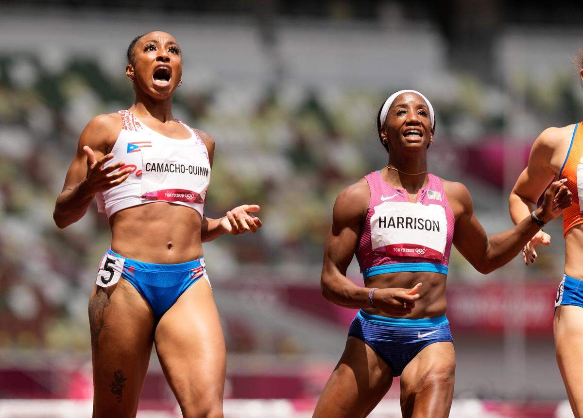 Jasmine Camacho-Quinn, of Puerto Rico, left, celebrates after winning the gold in the women’s 100-meters hurdles final ahead of Kendra “Keni” Harrison, of United States, silver, at the 2020 Summer Olympics, Monday, Aug. 2, 2021, in Tokyo, Japan.