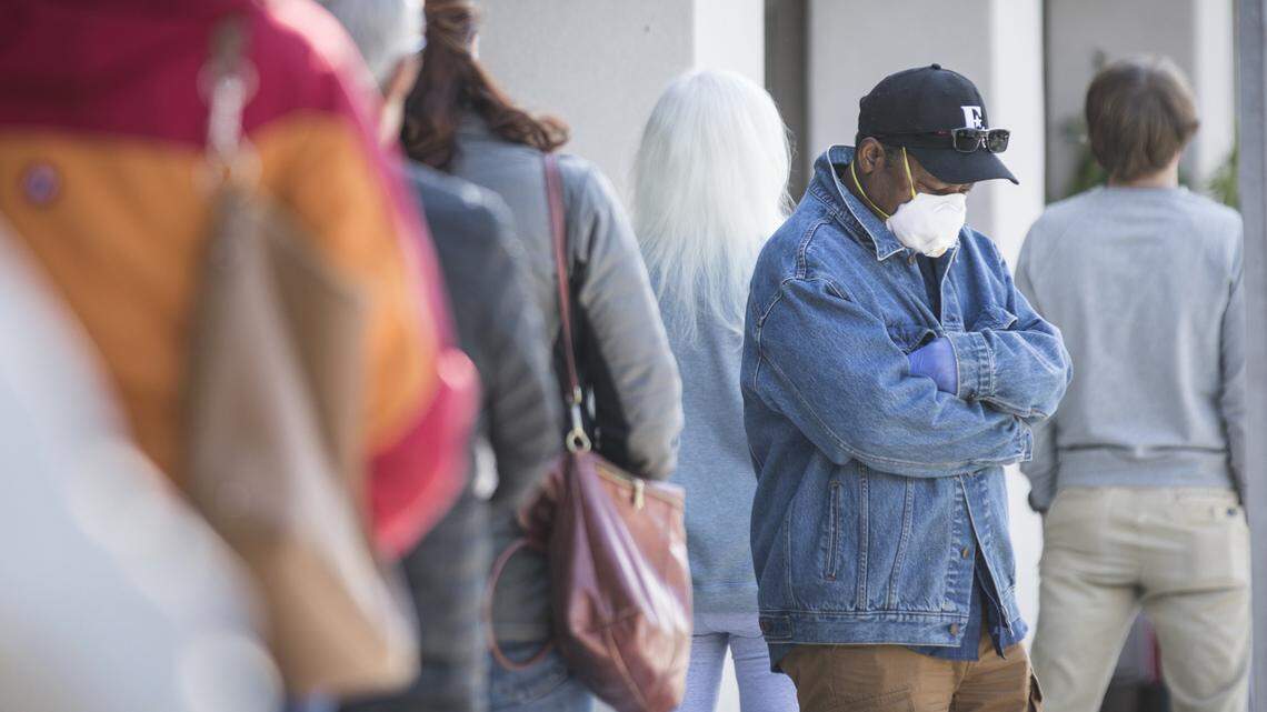 Patrons of the Whole Foods in Chapel Hill, N.C. wait in line at least six feet apart to get inside to shop on Friday, April 10, 2020.